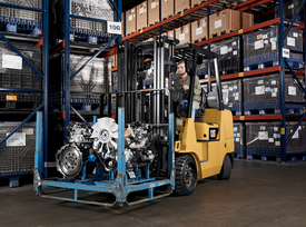 CAT Forklift moving engine parts in a manufacturing facility