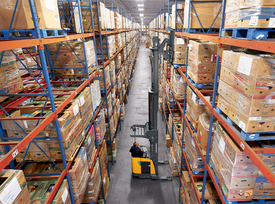 Forklifts lifting pallets in a warehouse rack